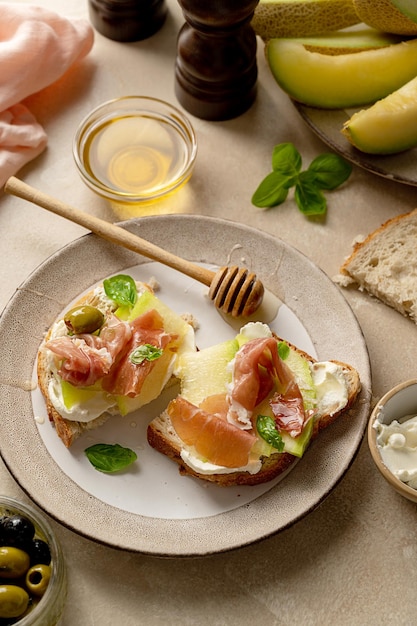 Melon with prosciutto toast with basil and honey Antipasti snack