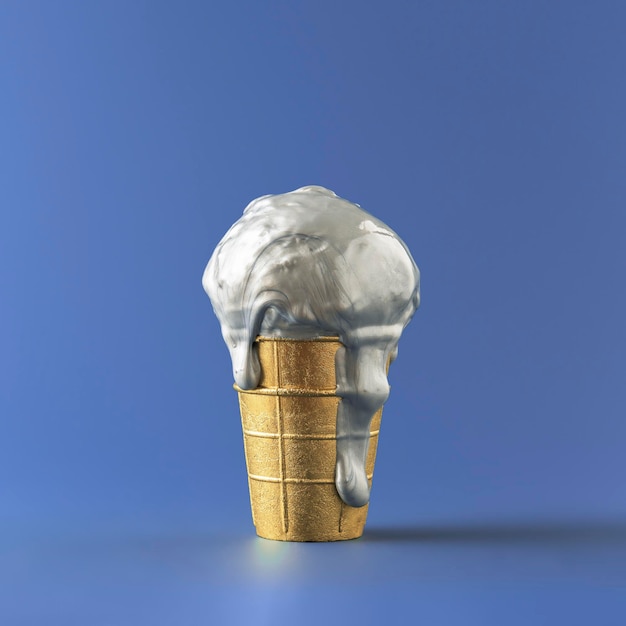 Melting metallic ice cream in a gold cup on a blue background Creative concept for a premium sale