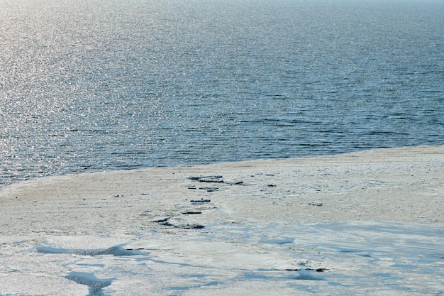 Melting sea ice seasonal natural phenomenon of coming spring ice on water melts from burning sun