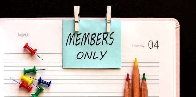 Members Only on the stickers on the diary with office tools