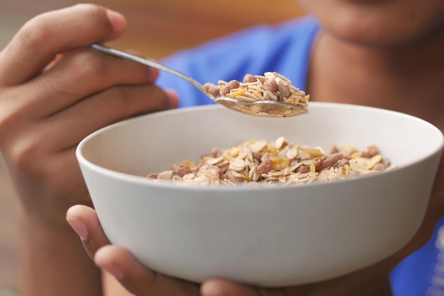 Men eating granola Musli in a bowl