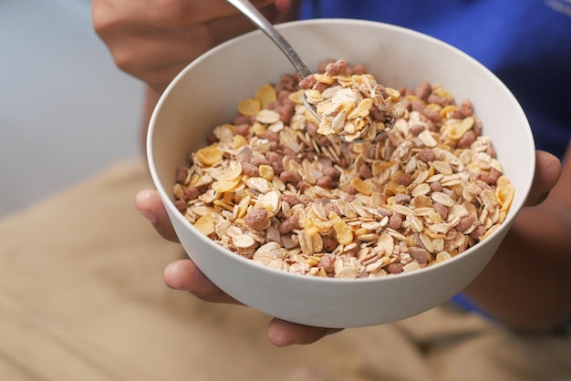 Men eating granola Musli in a bowl