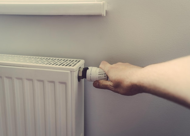 Men hand at the battery temperature controller heating close up