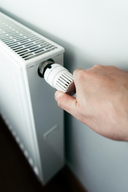 Men hand on the battery temperature controller heating close up