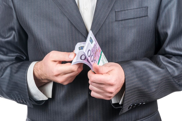 men hands in a jacket count money in a pack of five hundred euro, isolated on white background