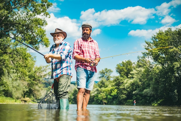 Men hobby and recreation Fishermen successful catch fish Fisher retirement Retired businessman in suit with fishing rod Male friendship Granddad and drandson fishing