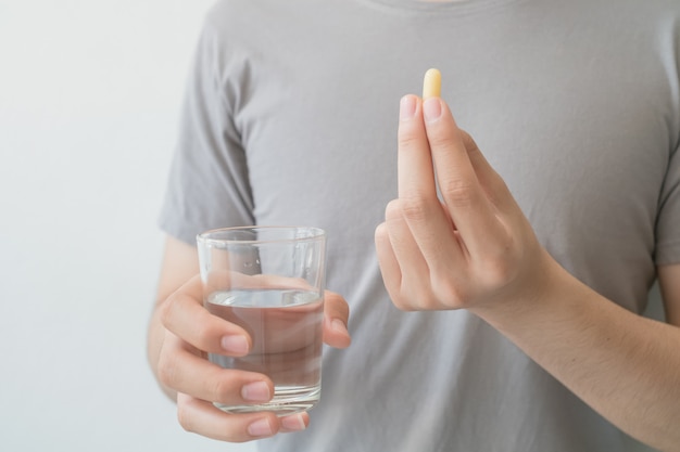 Men hold medicine and water in their hands. Medical and health concepts