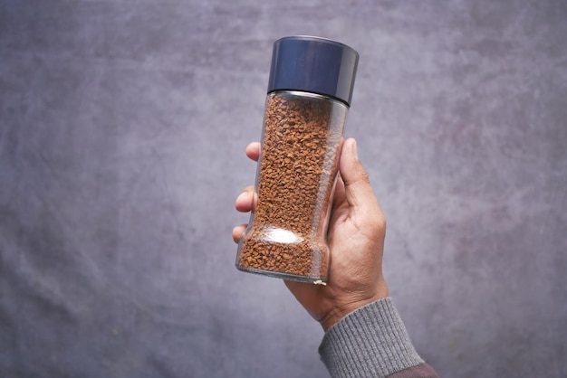 Men holding a coffee powder jar on table