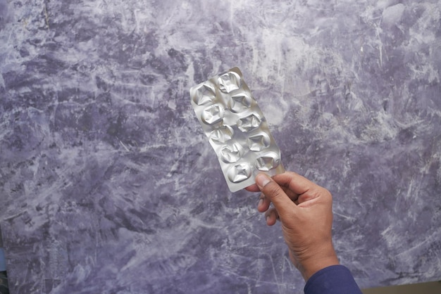 Men holding a empty pills of blister pack