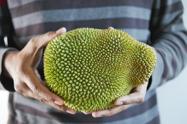 Men holding a jackfruit close up