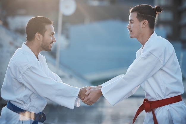 Men karate and handshake at training fight for respect fitness or workout contest for development Martial arts teacher coaching and smile for exercise zen mindset or outdoor for combat sports