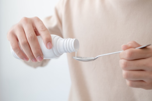 Men pouring drugs or antacids in their hands because of the food from their hands to the bottle