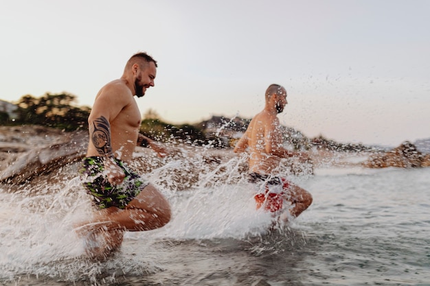 Men running down to the sea