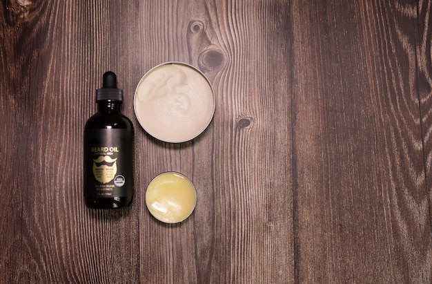 Men's beard balm, wax on wooden background.