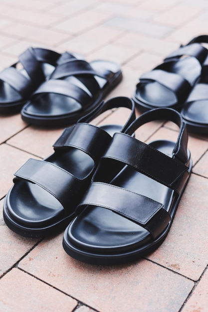 Men's black leather sandals stand on an isolated background Summer collection of men's shoes