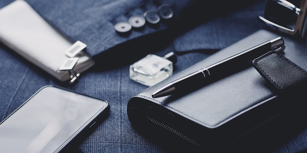 Men's fashion accessories: tie, perfume, cufflinks, wallet, smartphone and luxury pen