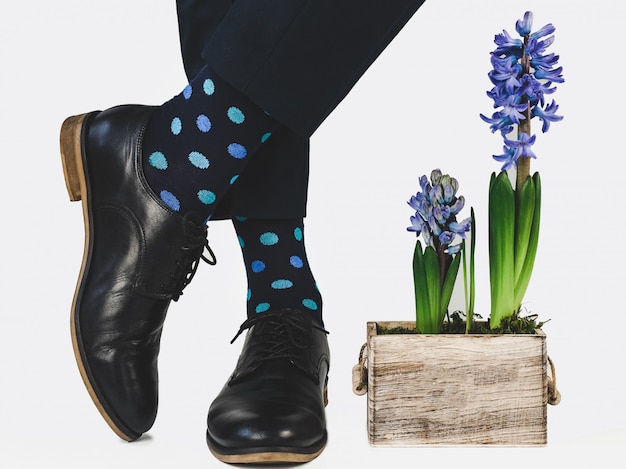 Men's feet, blue pants and bright socks