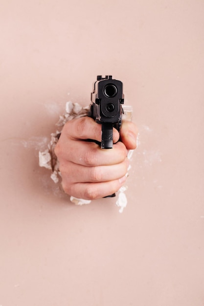 Men's hand with a gun