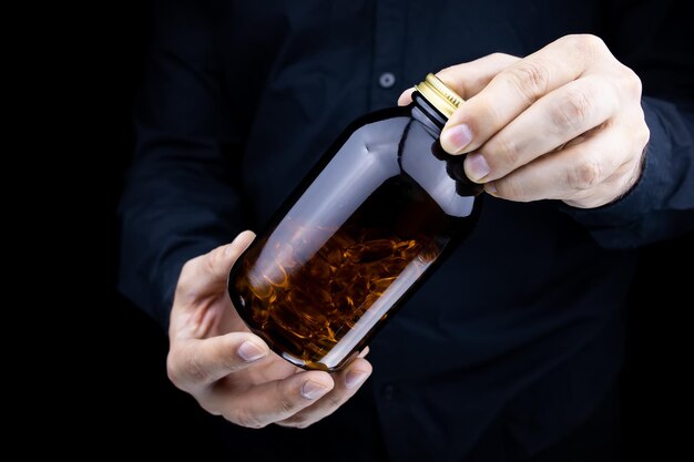 Men's hands hold a jar of fish oil capsules