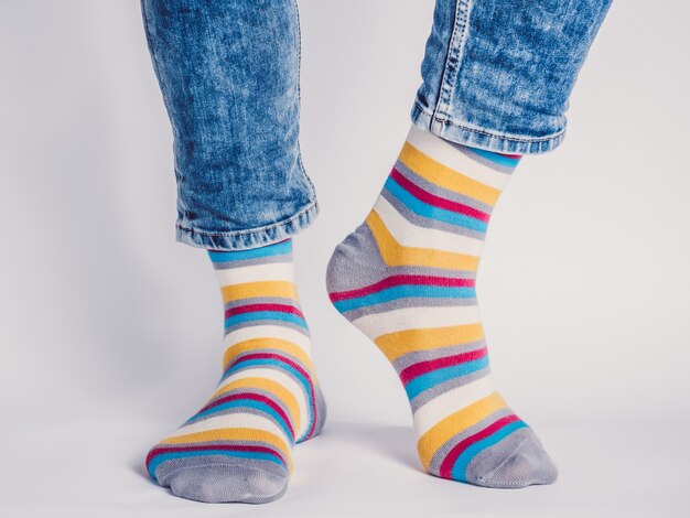 Men's legs and bright socks. Without shoes. Close-up. Style, beauty and elegance concept