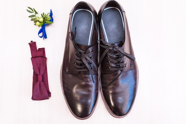 Men's shoes, butterfly and groom's boutonniere