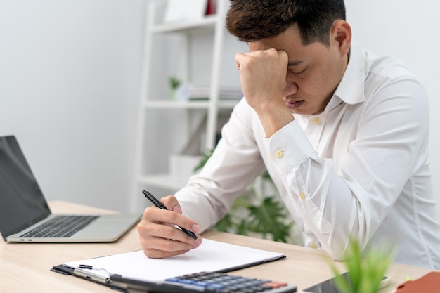 Men sit stressed with problems inside the office A man is sad and disappointed is lonely Loneliness and disappointment with life and business