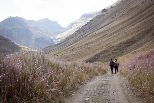 Men walk in the mountains along a dirt road