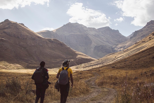 Men walk in the mountains along a dirt road