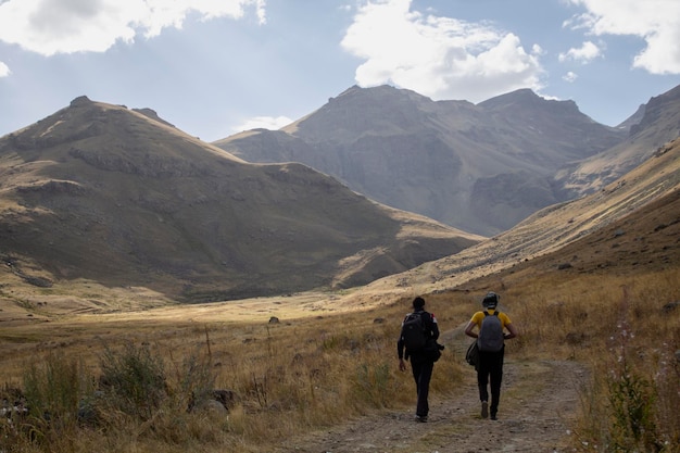 Men walk in the mountains along a dirt road