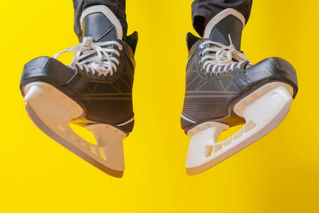 Men wear skates isolated on yellow background f