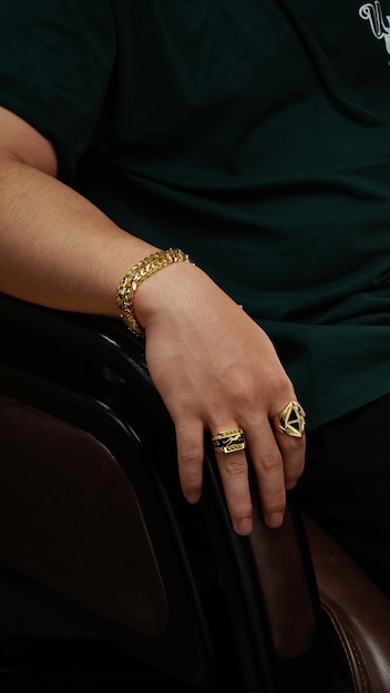 men wearing a golden bracelet on hand and rings of gold