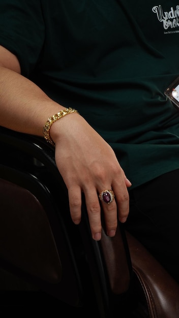 men wearing a golden bracelet on hand and rings of gold