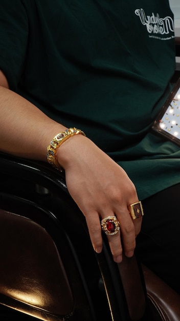 men wearing a golden bracelet on hand and rings of gold