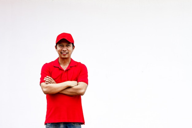 Men wearing red shirts and hats stand happily with their arms crossed.