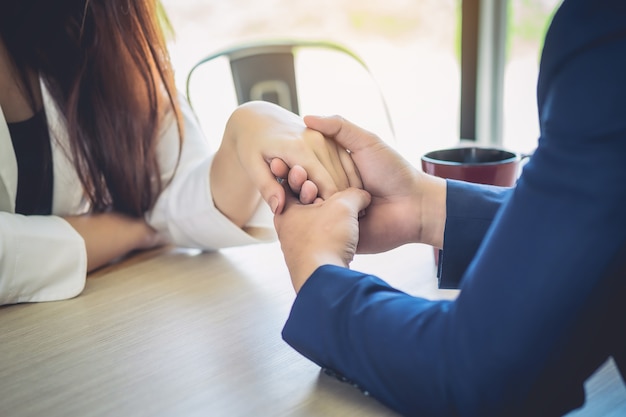 Men and women are holding hands to consult and comfort each other