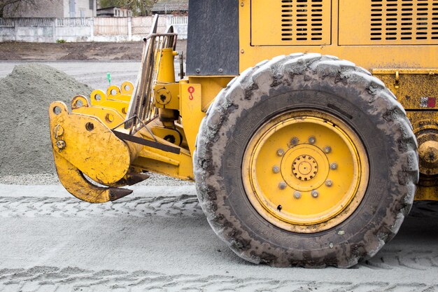 Men at work, asphalt laying. Road-building. Road construction machinery. Road grader