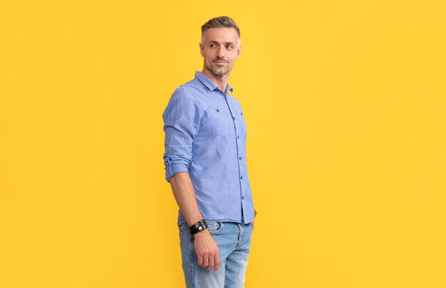 Mens beauty hoary man portrait with grizzled hairstyle confident man with gray beard hair and beard care male fashion model on yellow background handsome guy with graying bristle