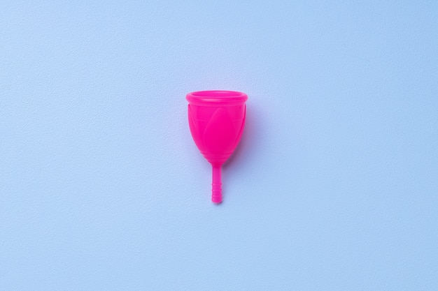 Menstrual cup on blue surface top view