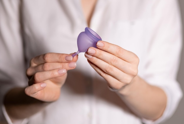 Menstrual cup in the hands of a woman