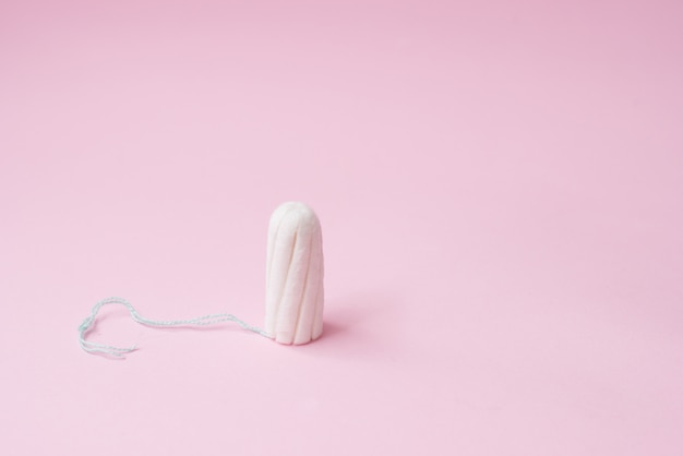 Menstrual tampon on a pink. Menstruation time. Hygiene and protection. copyspace