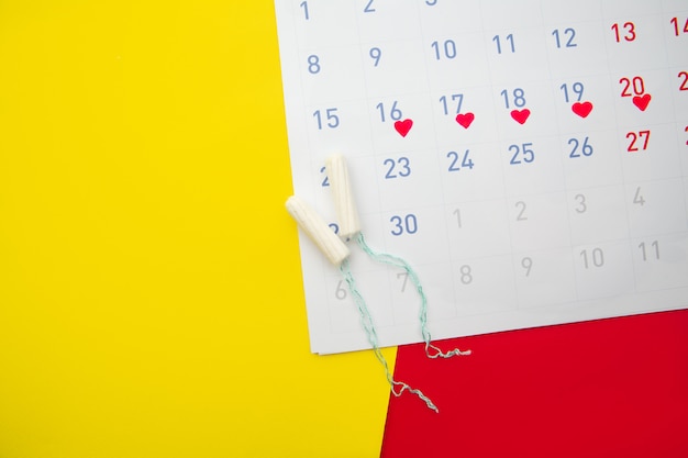 Menstruation calendar with cotton tampons.Woman critical days, woman hygiene protection concept