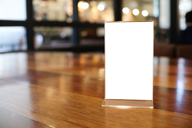 Menu frame space for text marketing promotion standing on wood table in Bar restaurant cafe