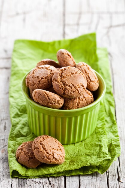 Meringue almond cookies in a green bowl 