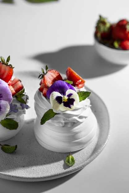 Meringue caked with pansies on a plate