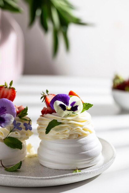 Meringue caked with pansies on a plate