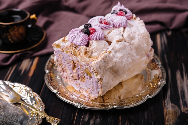 Meringue roll cake with cream and berries