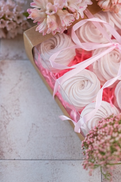 meringues in gift box and pink flowers