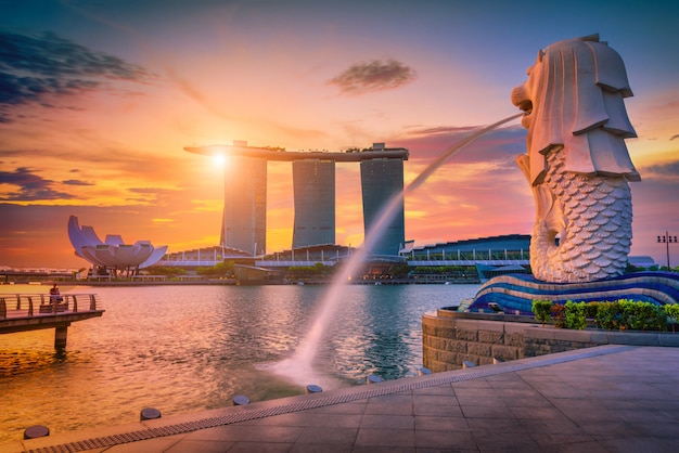 Merlion statue fountain in Merlion Park and Singapore city skyline . One of the most famous tourist attraction in Singapore.