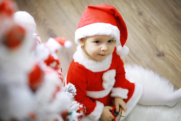 Merry bright christmas Lovely baby enjoy christmas Childhood memories Santa girl little child celebrate christmas at home Family holiday Girl cute child cheerful mood play near christmas tree