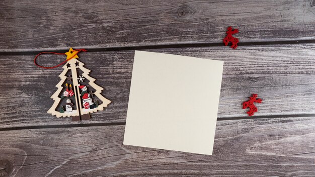 Merry Christmas blank greeting card on a wooden background.